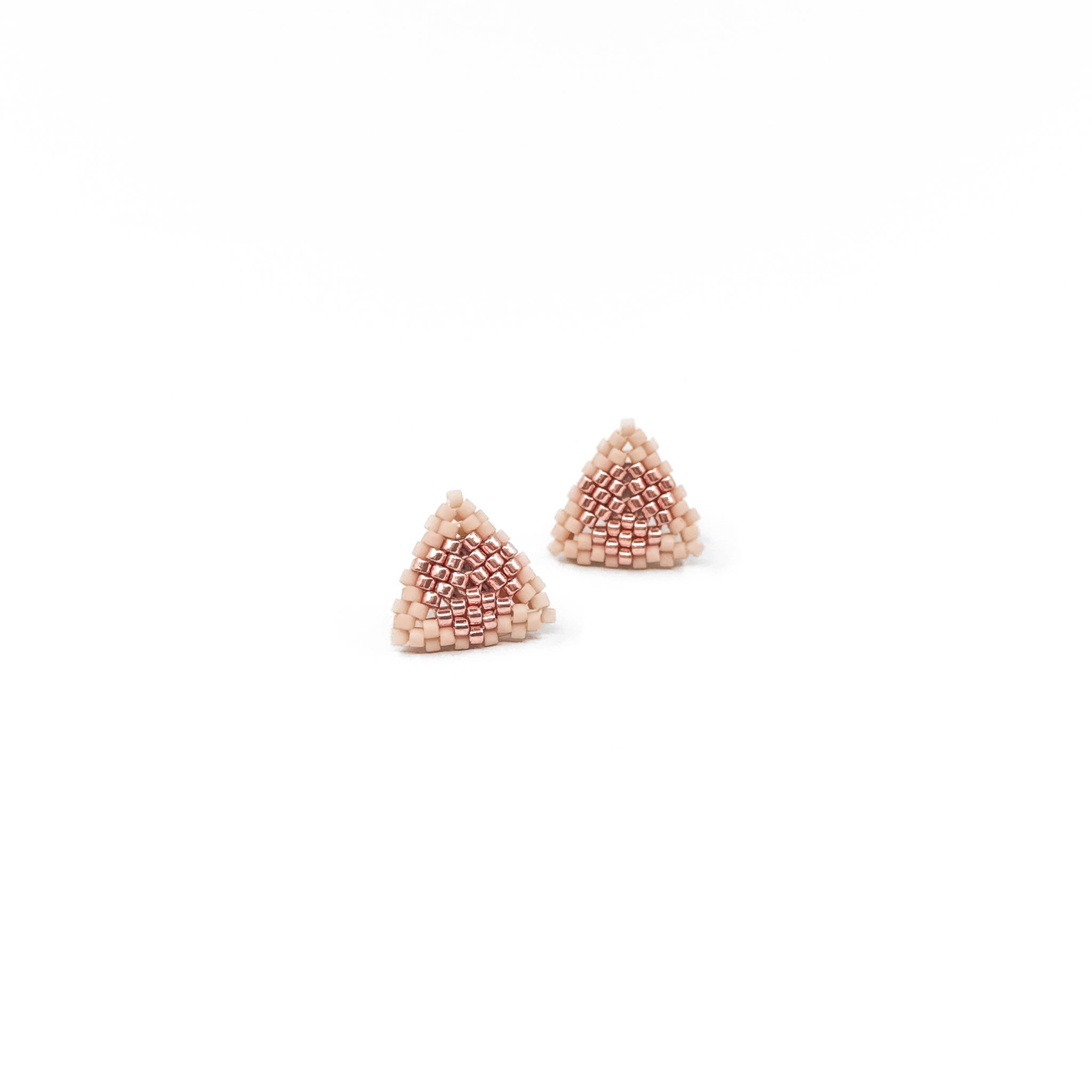 Pink beaded triangle stud earrings with metallic center detail, blush pink beads, front view.