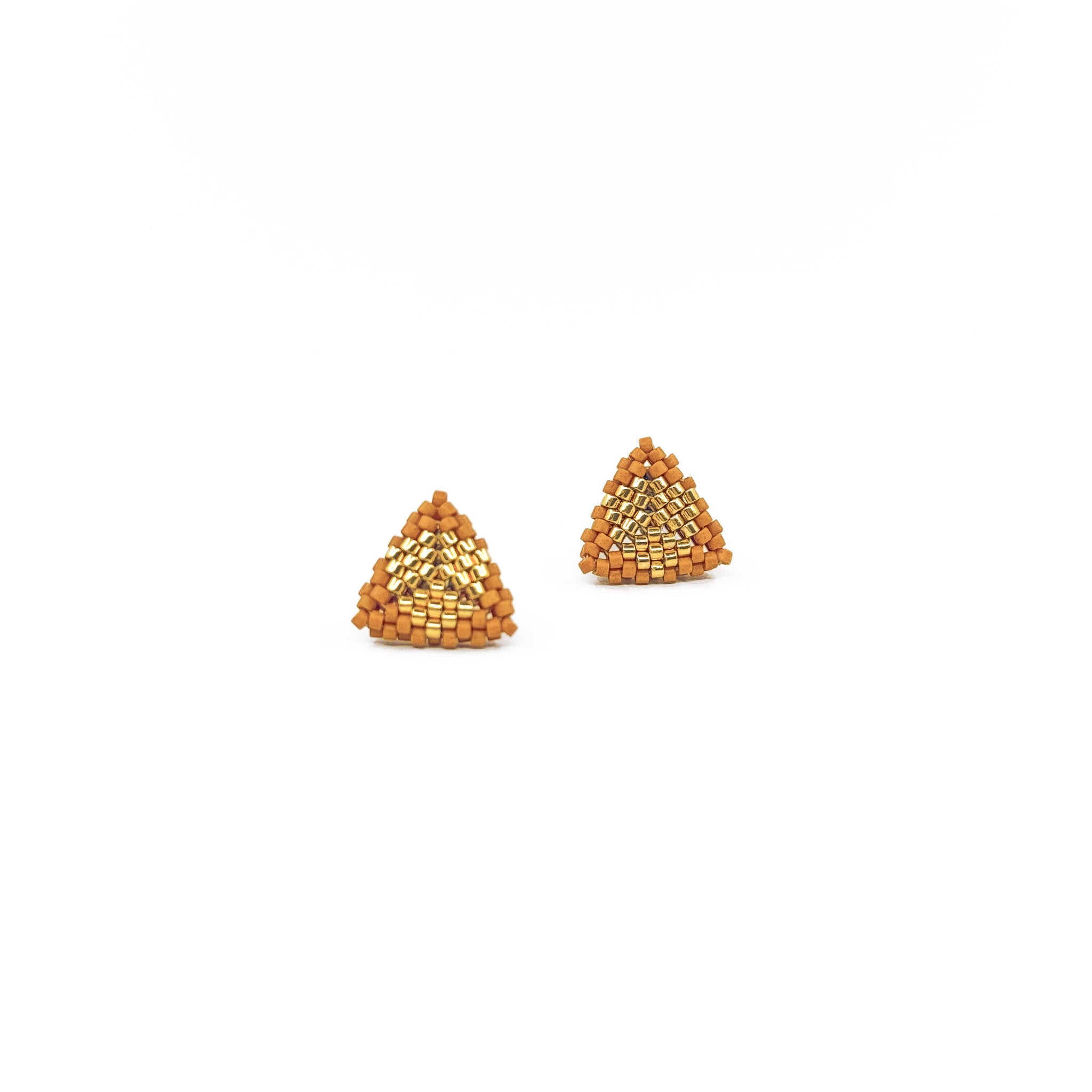 Orange beaded triangle stud earrings with metallic center detail, terracotta and  gold color beads, front view.