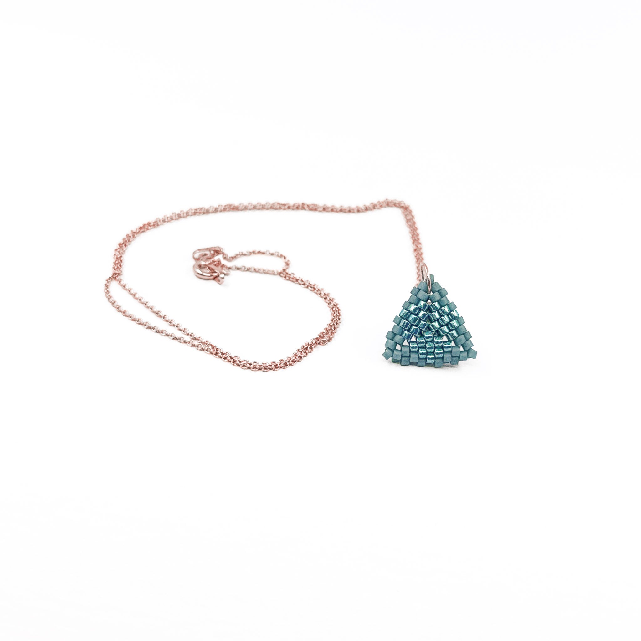 Blue beaded triangle pendant on a rose gold chain with metallic center detail, slate blue beads, front view.
