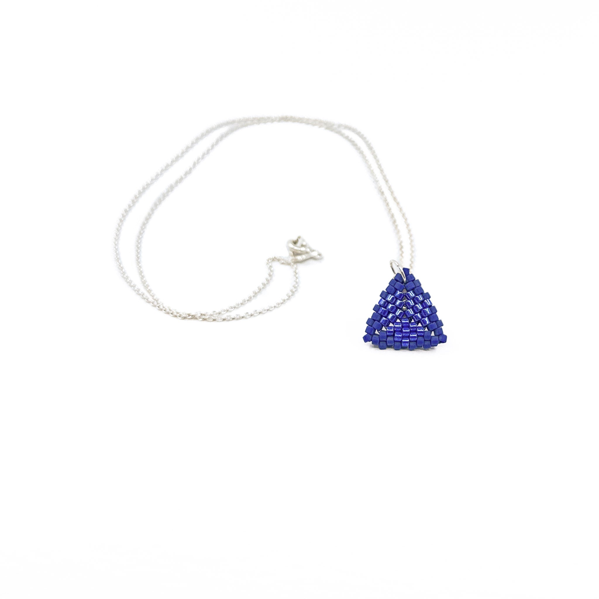 Blue beaded triangle pendant on a silver chain with metallic center detail, royal blue beads, front view.