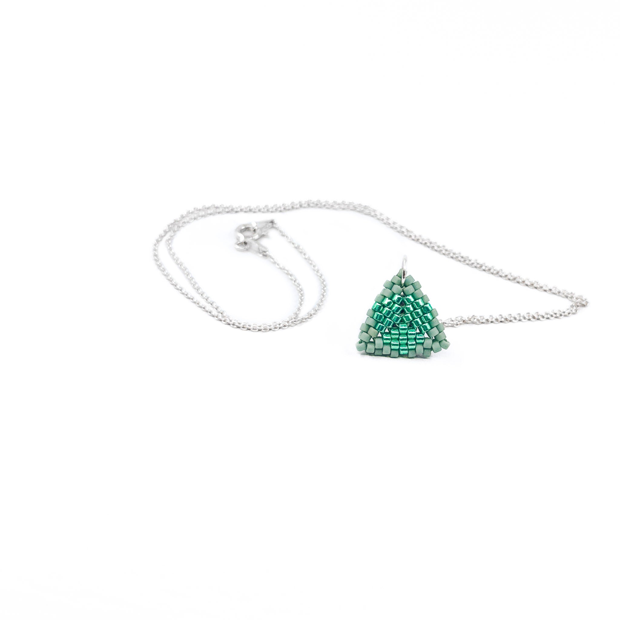 Green beaded triangle pendant on a silver chain with metallic center detail, sage and emerald beads, front view.