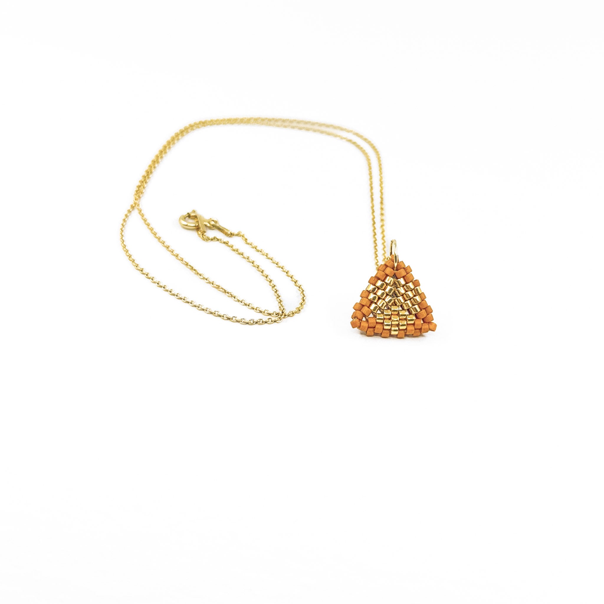Orange beaded triangle pendant on a gold chain with metallic center detail, terracotta colored beads, front view.
