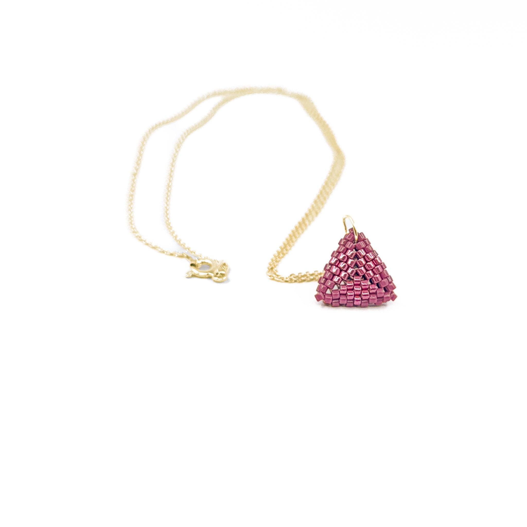 Pink beaded triangle pendant on a gold chain with metallic center detail, berry pink beads, front view.